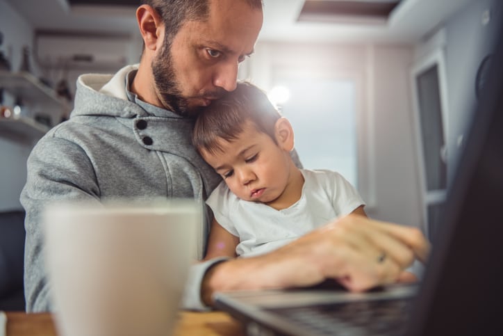 father_child_toddler_parent_consumer_workfromhome_working_laptop_childcare_family_finances.jpg