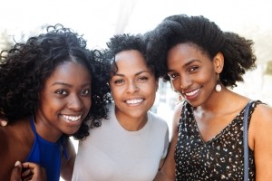 Three Black women with different hair textures