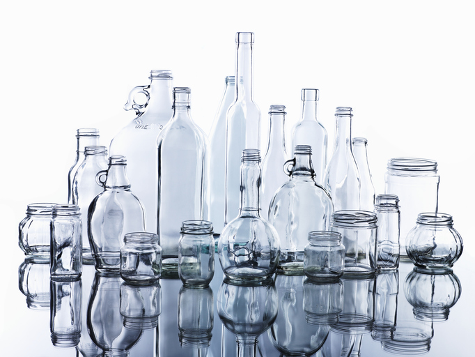 Assortment of glass bottles displayed on white background